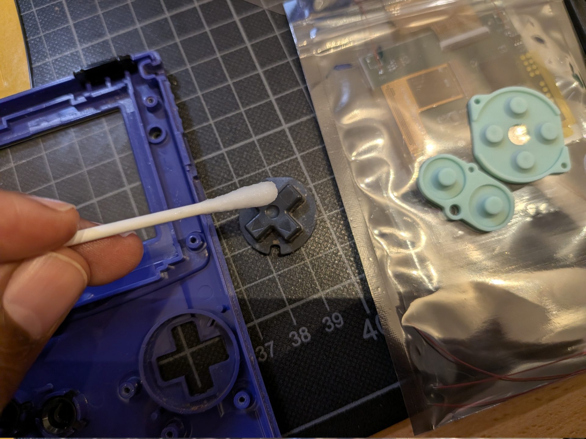 Cleaning the D-Pad with a wet cotton swap