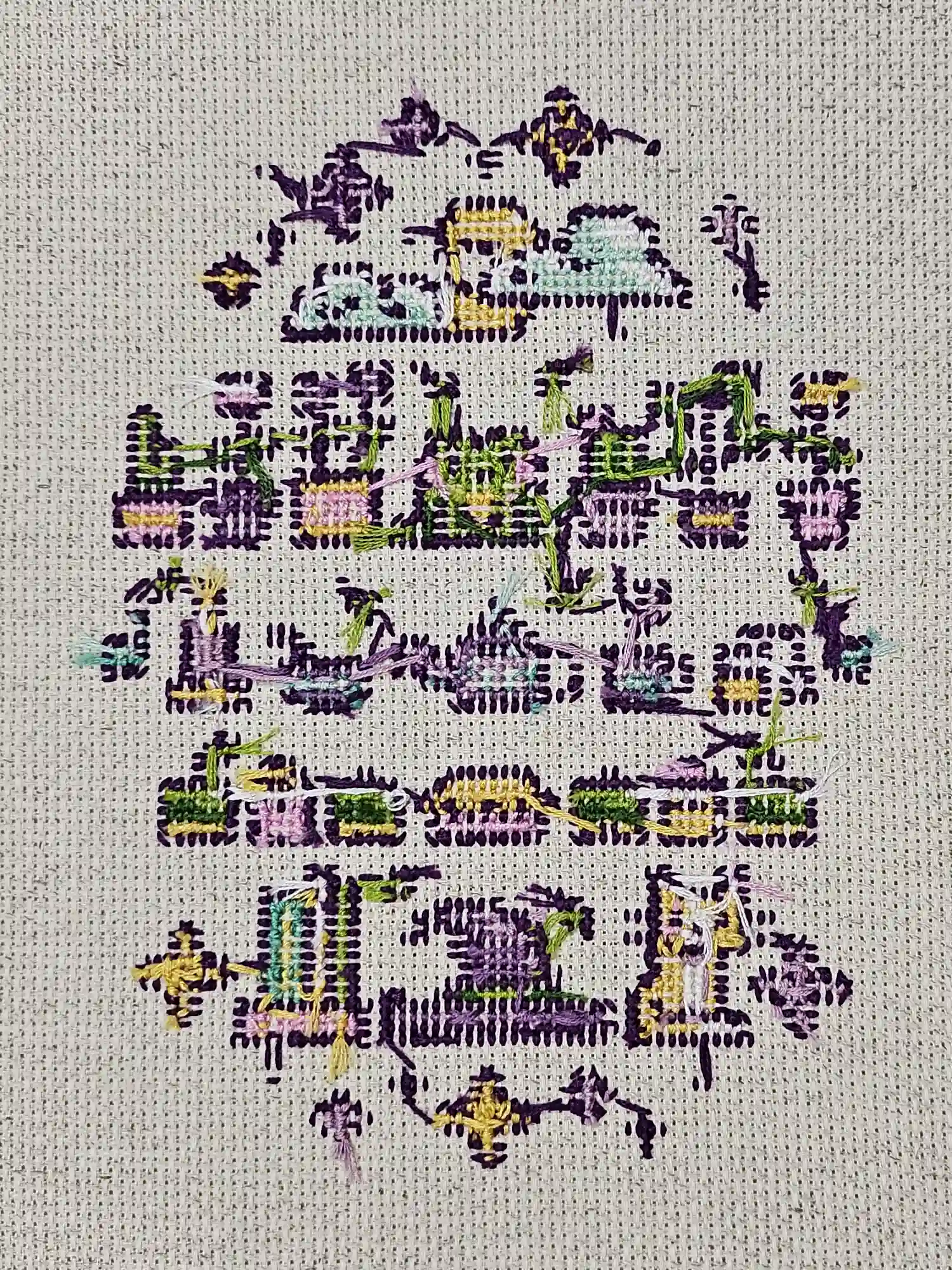 The backside of a cross stitch pattern. The frog and plants are still pretty clear. Cross-stitch.
