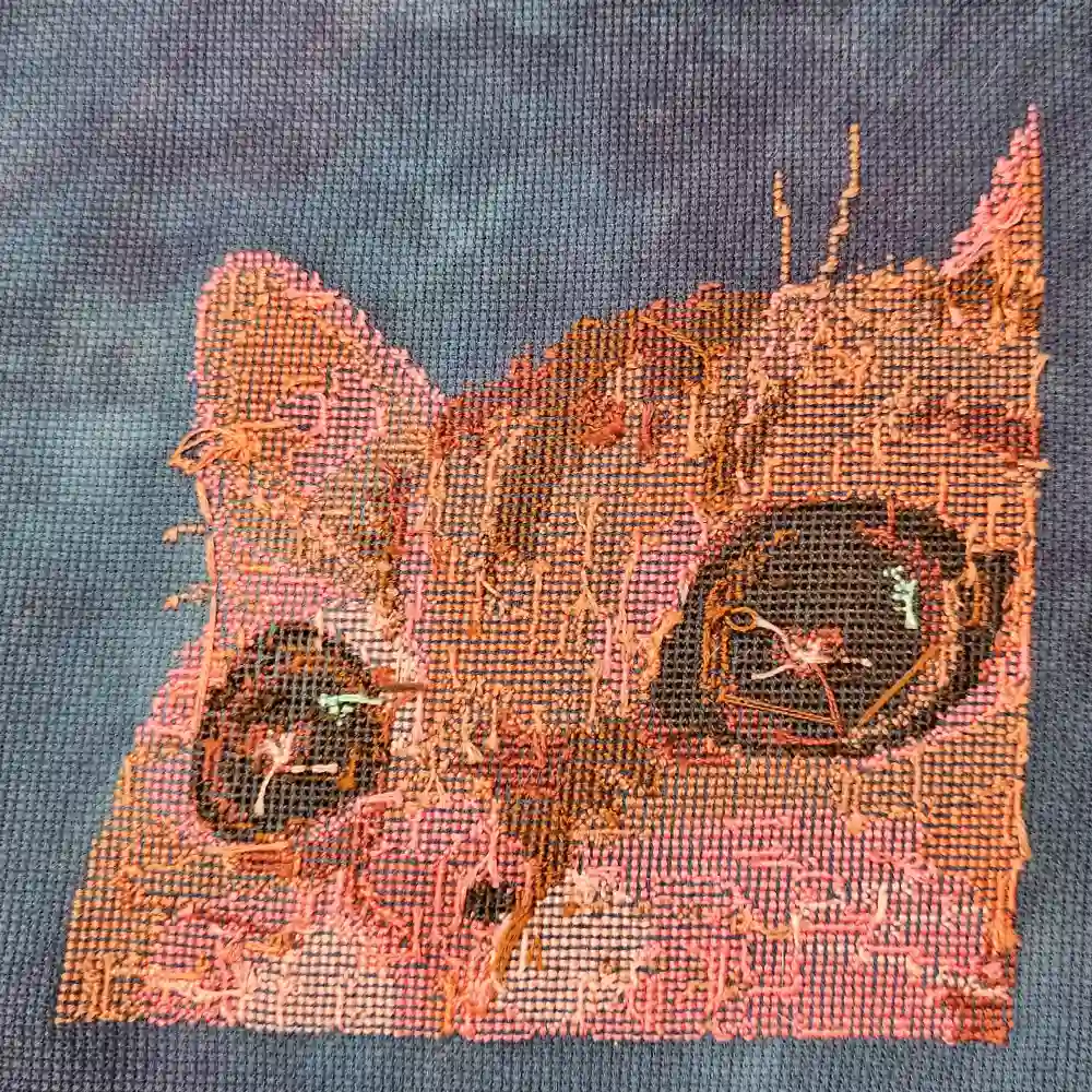 The neat back of the cat cross stitch.