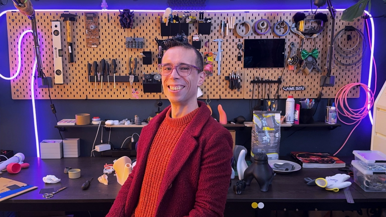A selfie of the author in their workspace, showing tools and works-in-progress.