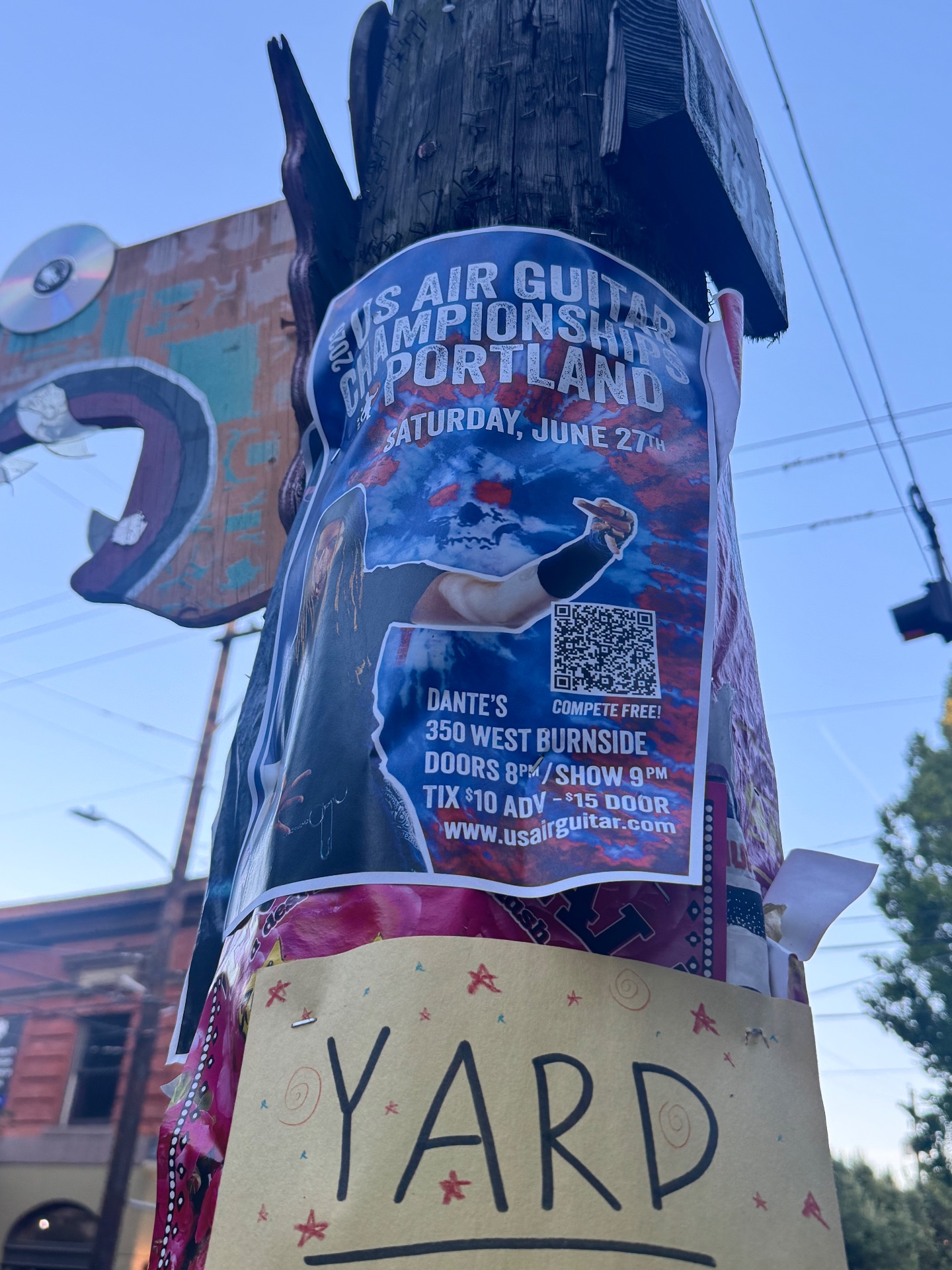 A telephone pole sign talking about air guitar championships