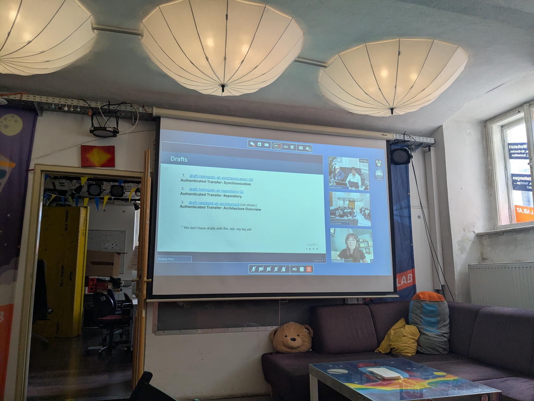 The big screen in the Otter Space room of the Metalab in Vienna with the IETF 126 atproto working group session projected.