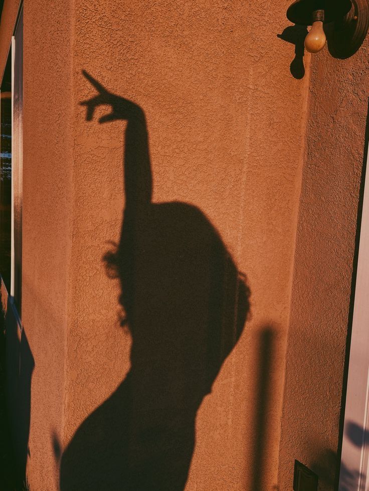 Shadow of a female body in a wall