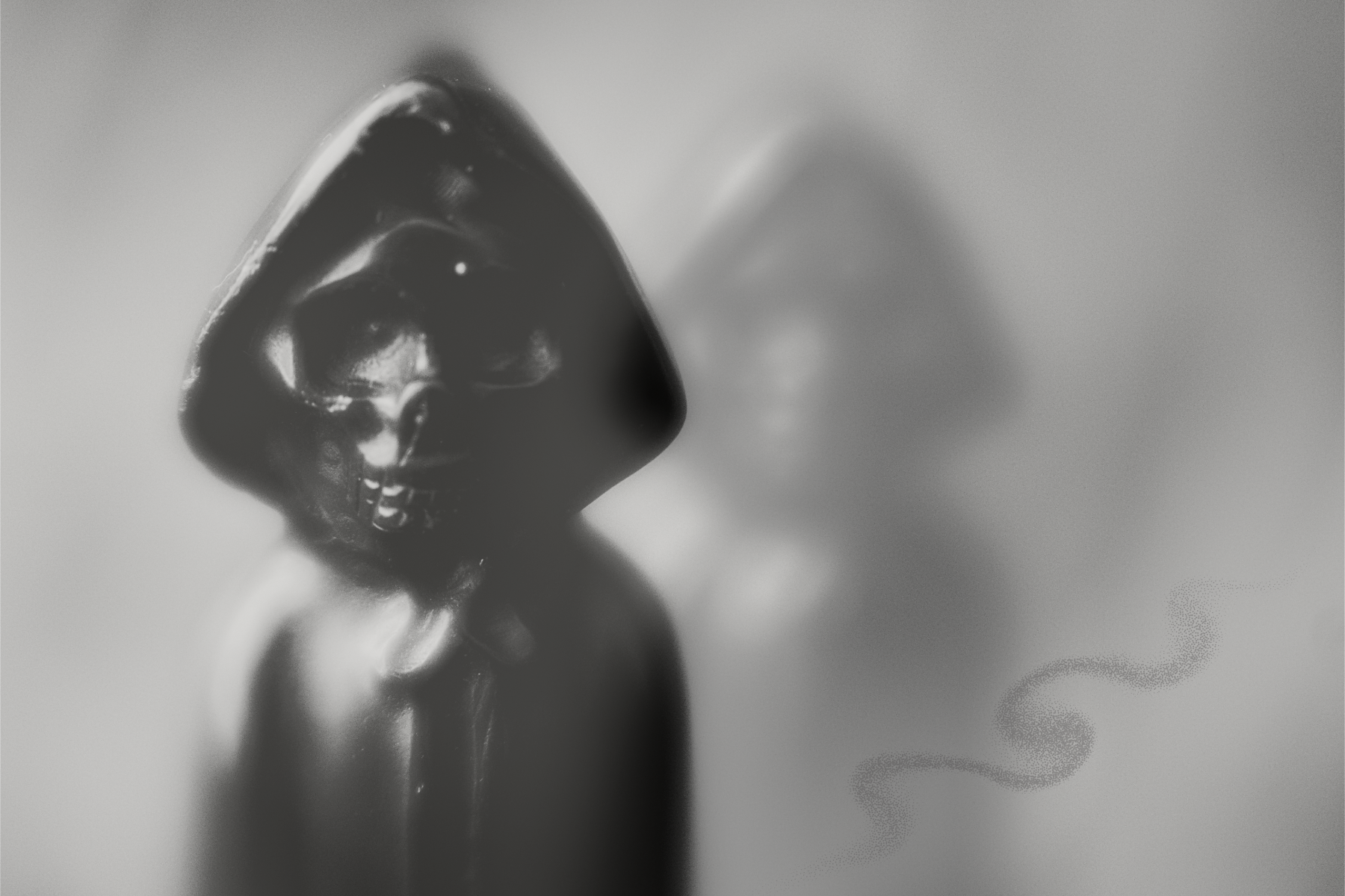 composite image made in Adobe Express - an image that looks like double exposure of an obsidian statue in the shape of a skeleton with a cloak, one in focus front left and his shadow in the back toward the right. Then, there is a small twisted line in the front right that looks like a faint twisted path.