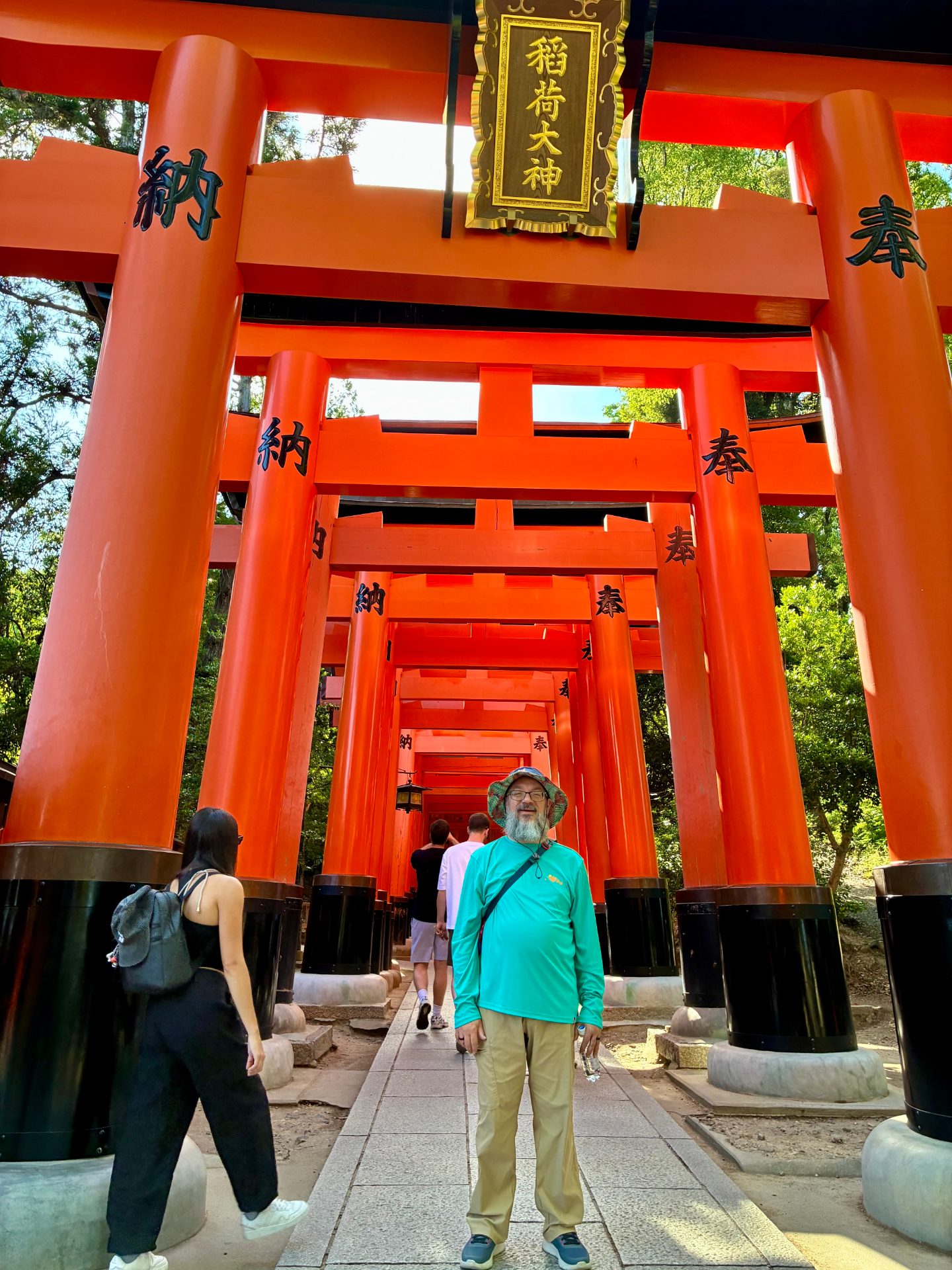 Yours truly standing in front of the first of many many red Torii gates on the Fushimi-Inari mountain hike. You can see several gates behind the first slowly getting smaller into the distance.