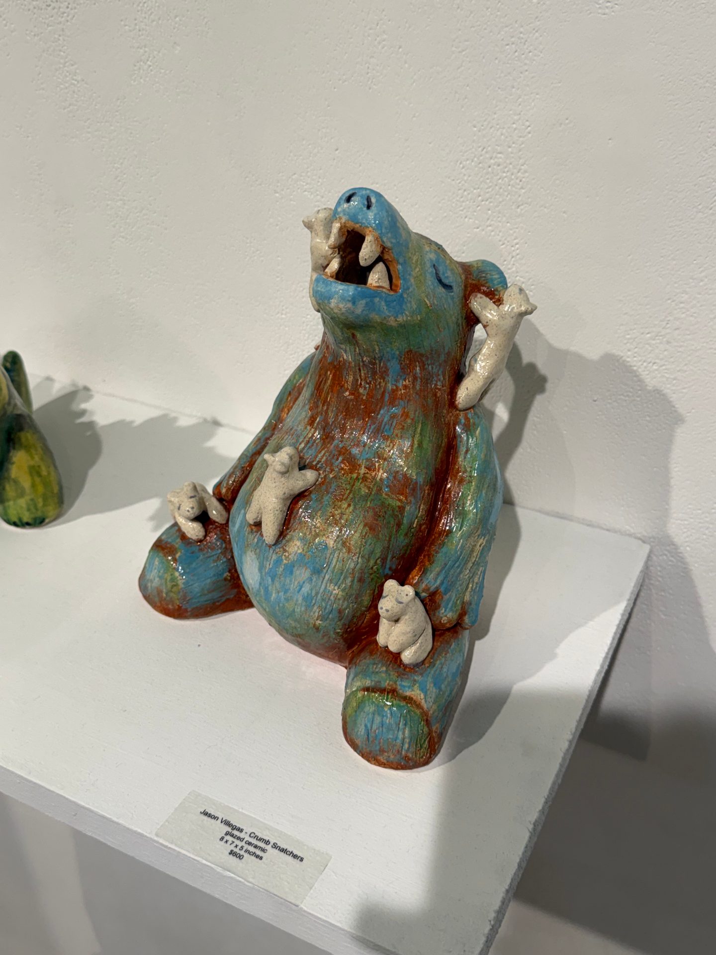 sculpture of bear with baby bears hanging on