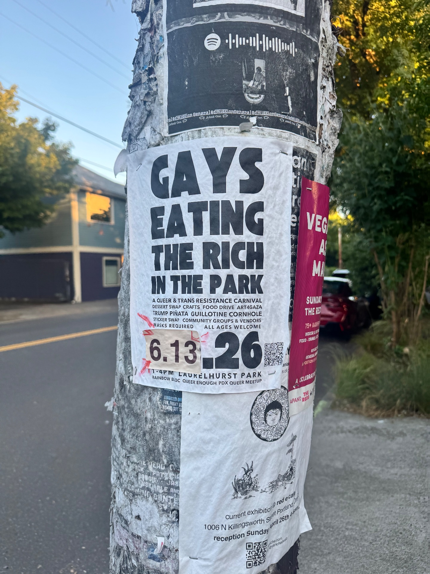 A telephone pole sign that says gays eating the rich